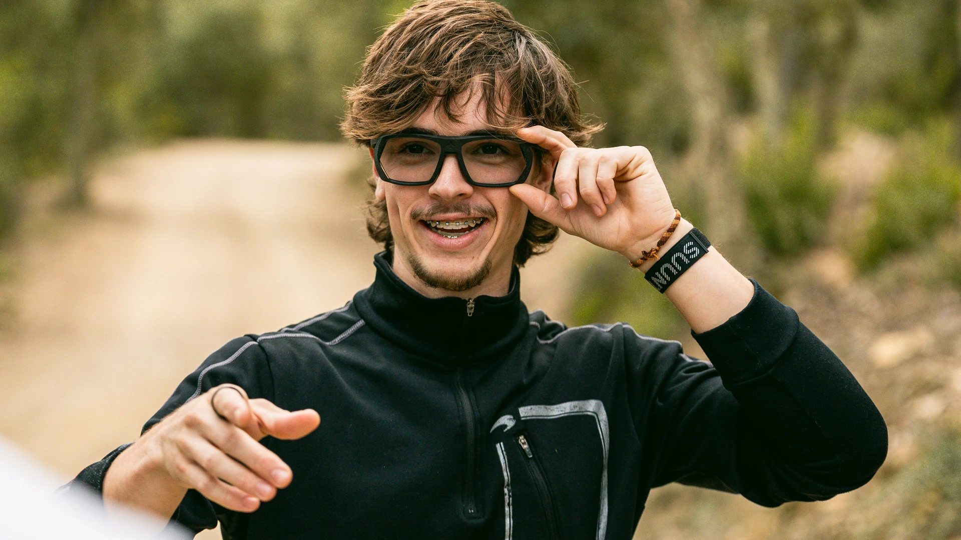 Young man wearing LLUM Spectacles and smiling into the camera.